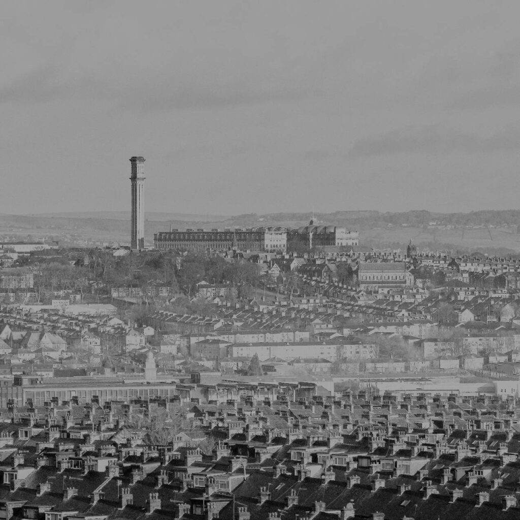 Black & white photo of Lister Mill and the Bradford skyline